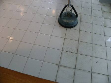 High-temperature tile cleaning tool mid-job - visible stripe between dirty and clean tile