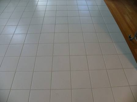 Bright clean white tile floor with restored grout lines after professional cleaning