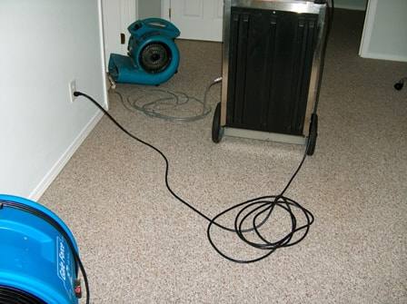 Drying setup with airflow fans and dehumidifiers after water damage